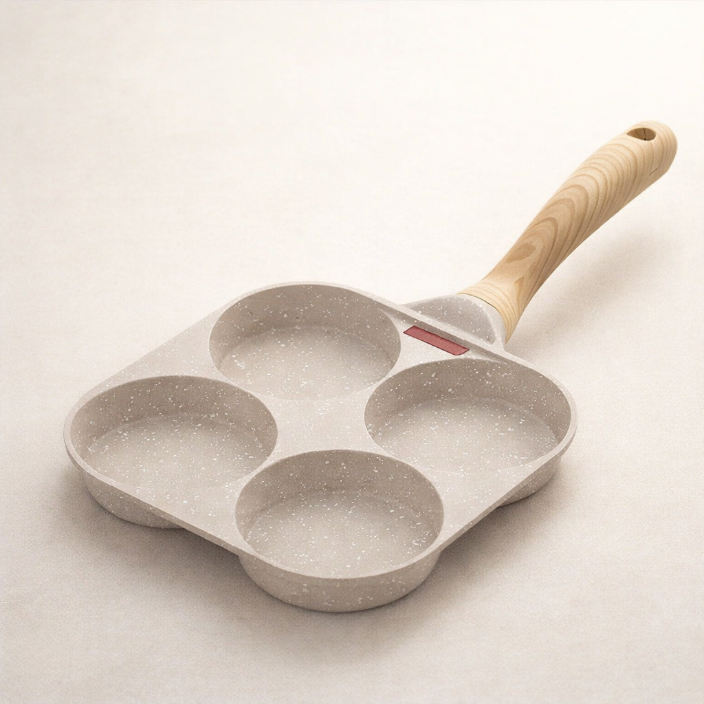 Gray speckled four-socket frying pan with a wooden handle on a light beige background