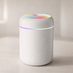 White cylindrical device with colorful top on a beige background