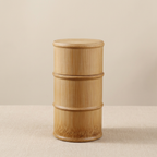 Wooden cylindrical container on a beige background